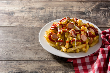 Typical Latin America Salchipapa. Sausages with fries, ketchup. Copy space