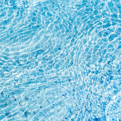 In the summer, the sun shines and the background of water waves flickers. The texture of the water.