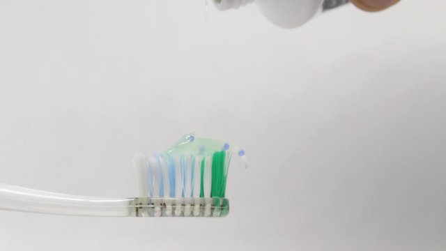 Close-up of squeezed tooth on the toothbrush