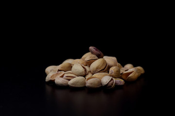 pistachio nuts isolated on black background