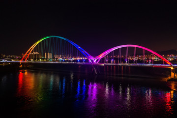Fototapeta na wymiar Crescent Bridge - landmark of New Taipei, Taiwan with beautiful illumination at night, photography in New Taipei, Taiwan.