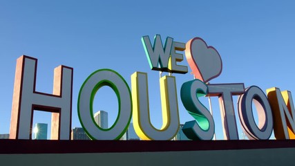 We love Houston sign with the city skyline in the background on a blue clear sky and sunny day