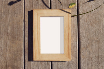 Wooden photo frame on wooden background