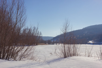 Winter snowy landscape with hills and trees