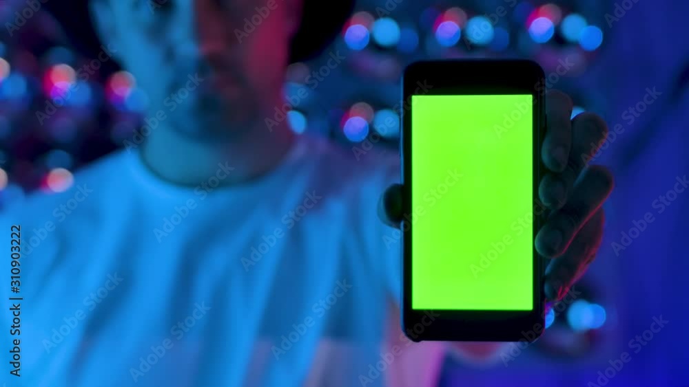 Aufkleber man using smartphone presents greenscreen. mobile phone browsing chroma key online. enjoying reading
