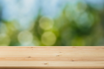 Wooden table in front of a blurred background. Perspective brown wood with blurry grunge or old wall backdrop - can be used to showcase or mount your products. Mock up to display the product.