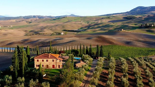 Aerial view of a luxury villa in Tuscany, Italy. aerial view next to a picturesque country road. Italy, Europe