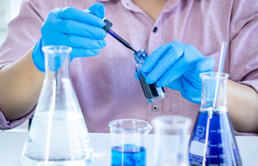 Fototapeta premium The concept of medical, chemicals or scientific laboratory research and Innovation in the laboratory. experienced man scientist is performing work chemical liquid in the laboratory.