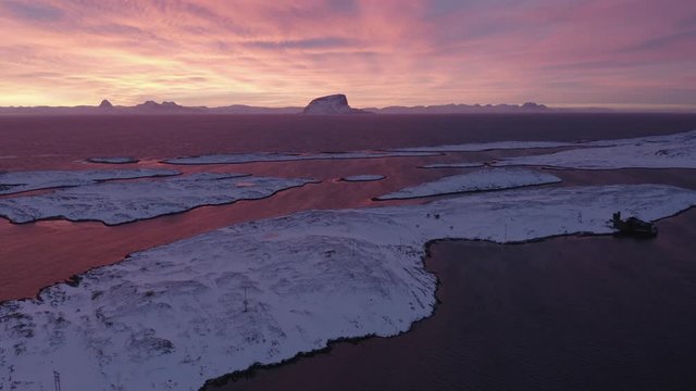 Winter sunrise Tr&aelig;na islands with Lovund in background, Nordland, Northern Norway, aerial drone shot