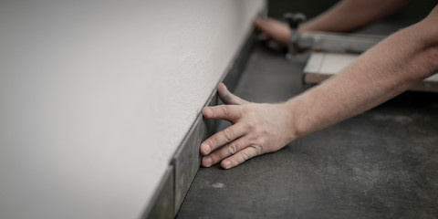 Fliesenleger bei der Arbeit, Renovierung eines Badezimmers