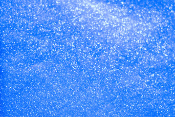 Abstract shiny blue Christmas background. Background for holiday cards. Blur, bokeh.