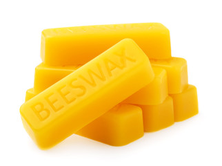 Bars of natural organic beeswax isolated on a white background. Production Ingredient for Medical and Cosmetics. The use of beeswax in apitherapy. - obrazy, fototapety, plakaty