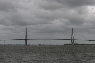 Panoramic vista of the Charleston bay and Arthur Ravenel Jr. Bridge on a heavily overcast day viewed from the water, South Carolina
