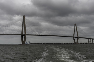 Panoramic vista of the Charleston bay and Arthur Ravenel Jr. Bridge on a heavily overcast day viewed from the water, South Carolina