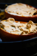 Pumpkin Hokkaido halves baked with meringue for Halloween. Healthy tasty weekend food.