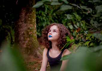 Naklejka na ściany i meble girl in blue lipstick contemplating the nature