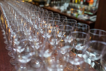 lot of empty glasses on the reception party table. Close up at row of glasses prepare to service for dinner party