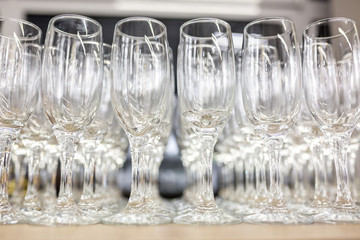 lot of empty glasses on the reception party table. Close up at row of glasses prepare to service for dinner party