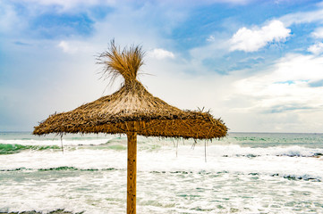 An umbrella on the beach in Santo Tomas, Menorca - Spain