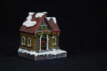 House on black background. Insurance and construction of houses.