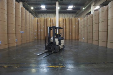 Forklift Truck And Huge Rolls Of Paper In Factory