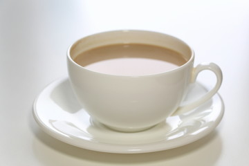 Coffee with milk. White cup. Soft brie cheese. Morning. Tasty breakfast.