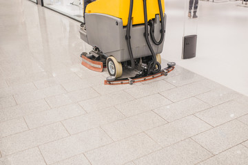 Clean tiles on the floor in the mall after wet cleaning with mechanized appliances
