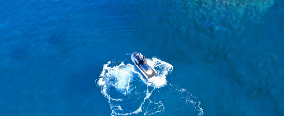 Aerial drone ultra wide top view photo of jet ski water craft cruising in deep blue Mediterranean sea