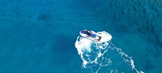 Aerial drone ultra wide top view photo of jet ski water craft cruising in deep blue Mediterranean...