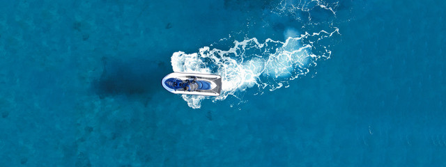 Aerial drone ultra wide top view photo of jet ski water craft cruising in deep blue Mediterranean...