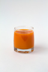 fresh juice drink on white table. glass of fresh pumpkin juice on a white background. 