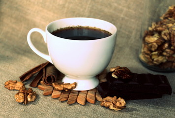 A cup of coffee. White dishes. Coffee and chocolate. Morning ritual.