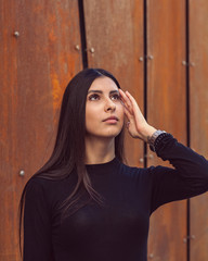 Beautiful girl model posing against the background of the modern building