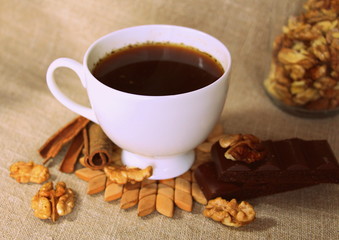 A cup of coffee. White dishes. Coffee and chocolate. Morning ritual.