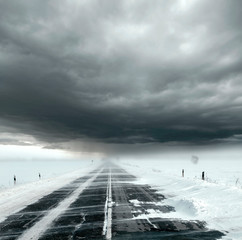 Stormy sky and snow road