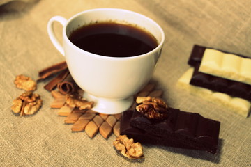 A cup of coffee. White dishes. Coffee and chocolate. Morning ritual.