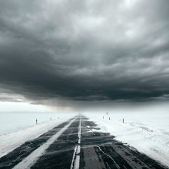 Stormy sky and snow road
