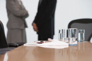 Midsection Of Business Couple With Focus On Table