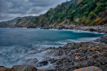 Fototapeta na wymiar The rocks of the bay of Rovaglioso, in the purple coast.