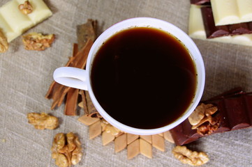 A cup of coffee. White dishes. Coffee and chocolate. Morning ritual.