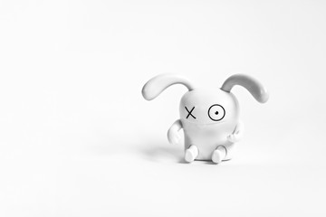 Figure of a funny white rabbit on a white background