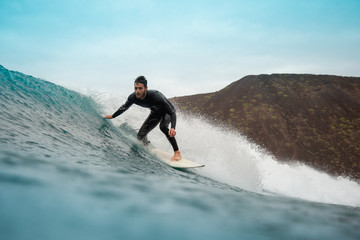 surfer riding waves on the island of fuerteventura