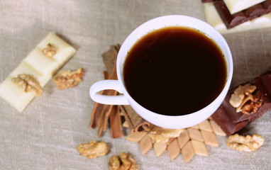 A cup of coffee. White dishes. Coffee and chocolate. Morning ritual.