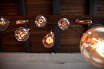 Edison lamp is included in loft room, against background of concrete wall