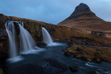 The iconic Kirkjufell waterfall during early gloomy morning. This waterfall is the most iconic waterfall in Iceland. 