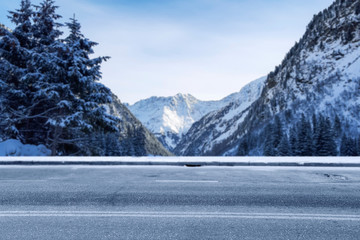 Winter background of road and mountains landscape 