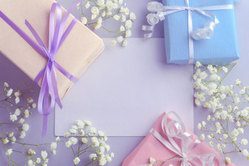 Beautiful gift box and flowers on light background