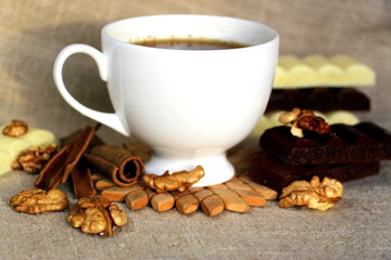 A cup of coffee. White dishes. Coffee and chocolate. Morning ritual.