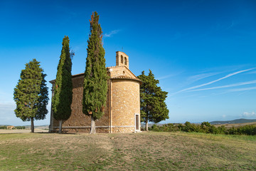 Fototapeta na wymiar Cappella di Vitaleta with cypresses in Tuscany, Italy.