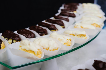 Eclairs with black and white chocolate.